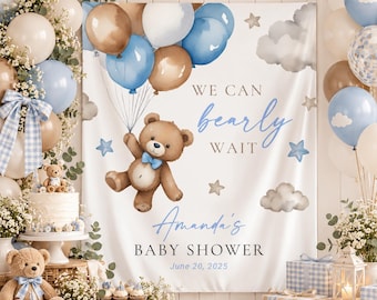 May include: A white fabric backdrop for a baby shower featuring a brown teddy bear holding blue and brown balloons. The text reads WE CAN bearly WAIT, Amanda's BABY SHOWER, and June 20, 2025, decorated with watercolor clouds and stars.