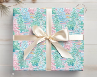 May include: A square gift box wrapped in paper featuring a repeating pattern of stylized pine trees in shades of pink, mint green, and light blue. A wide, cream-colored satin ribbon is tied in a bow around the center. The text "PERSONALIZABLE" is printed in the upper right corner.
