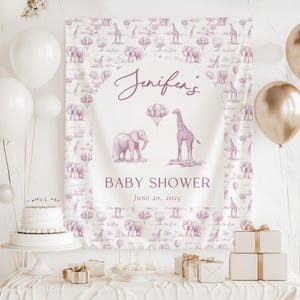 May include: A rectangular fabric backdrop featuring a repeating pattern of mauve elephants, giraffes, and balloons. The center displays the text Jenifen's BABY SHOWER June 20, 2025, with a central illustration of an elephant, a giraffe, and balloons.