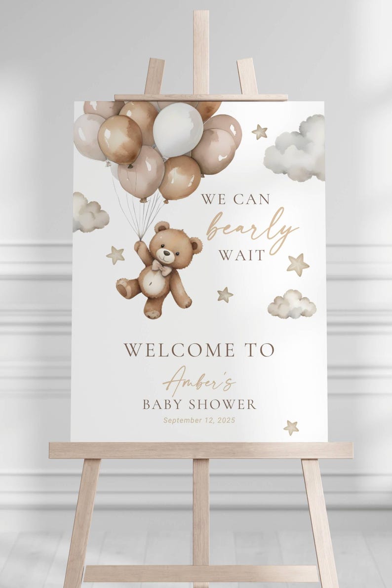 May include: A baby shower welcome sign on an easel. The sign features a teddy bear holding balloons, clouds, and stars. Text reads "We can bearly wait" and "Welcome to Amber's Baby Shower September 12, 2025."