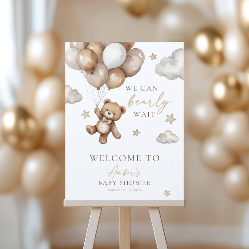 May include: A baby shower welcome sign on an easel. The sign features a teddy bear holding balloons, with the text "We can bearly wait" and "Welcome to Amber's Baby Shower September 12, 2025". The background is a soft, neutral color.
