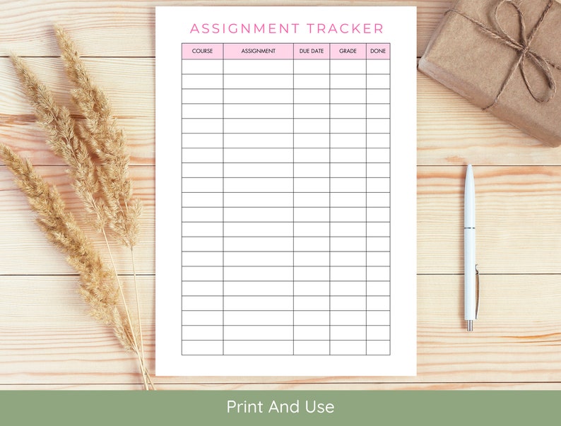 May include: A printable assignment tracker with columns for course, assignment, due date, grade, and done. The tracker has a pink header and is on a wooden surface.