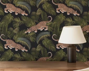 May include: A room featuring a wooden desk, chair, and a lamp. The wall is covered in wallpaper with a repeating pattern of leopards and tropical leaves in shades of green, black, and tan. The overall theme is a jungle or safari.