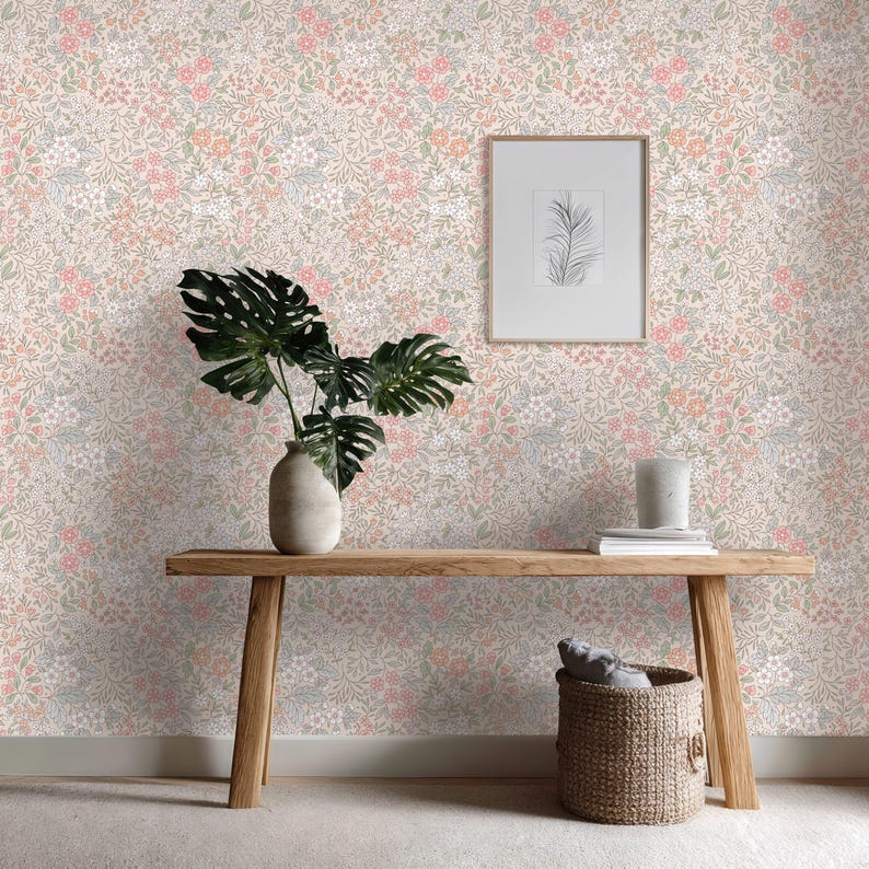 This image showcases the wallpaper pattern in an entryway setting. The pattern features a ditsy floral blossom design. The flowers are illustrated in shades of peach, coral, pink, and white against a beige background.