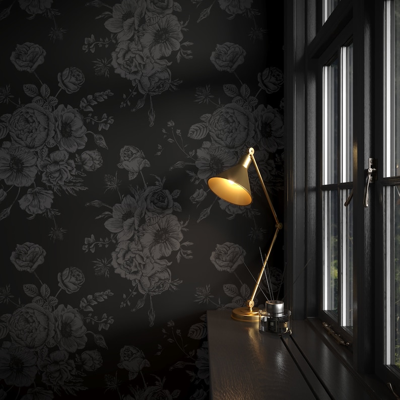 This image showcases the wallpaper pattern in an accent wall mockup. The wallpaper pattern has a solid black background with subtle dark grey floral illustrations.