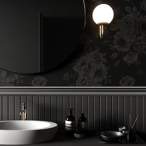This image showcases the wallpaper pattern in a bathroom mockup. The wallpaper pattern has a solid black background with subtle dark grey floral illustrations.