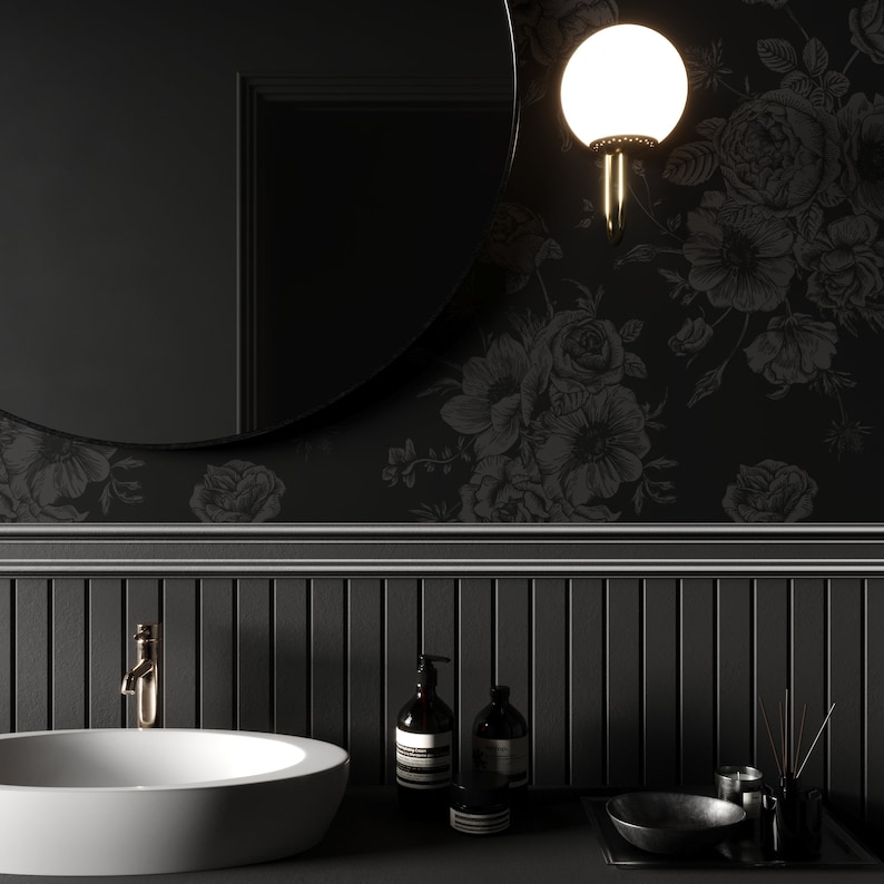 This image showcases the wallpaper pattern in a bathroom mockup. The wallpaper pattern has a solid black background with subtle dark grey floral illustrations.