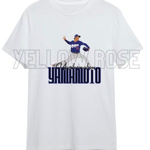 May include: White t-shirt with a blue and white illustration of a baseball player pitching. The text "Yoshinobu Yamamoto" is printed in blue below the illustration.