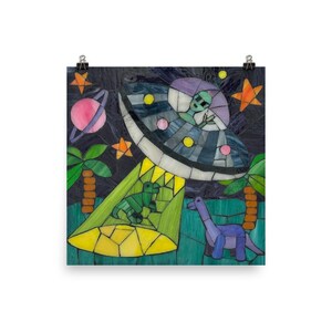 May include: A colorful mosaic art print depicting a UFO with an alien inside, beaming light onto two green dinosaurs. A purple planet with rings, stars, and palm trees are also featured in the artwork. The background is dark blue.