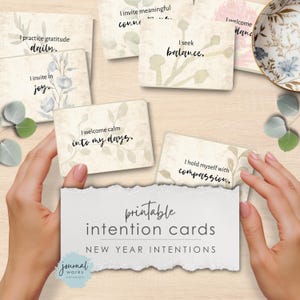 May include: A set of rectangular intention cards featuring botanical illustrations and text including I practice gratitude daily, I seek balance, I invite in joy, I welcome calm into my days, and I hold myself with compassion. A card reads printable intention cards.