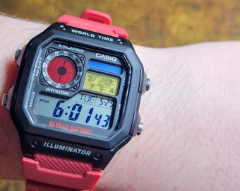 Casio World Time AE-1200WH pour hommes, module d'écran couleur rouge, bleu et jaune modifié sur mesure avec montre résistante à l'eau avec bracelet rouge