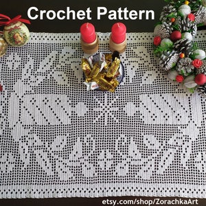 May include: White crochet table runner featuring a delicate floral design. The runner is adorned with red candles, a bowl of chocolate sweets, and a Christmas wreath with pine cones and red berries. The text "Crochet Pattern" is displayed at the top of the image. The text "etsy.com/shop/ZorachkaArt" is displayed at the bottom of the image.
