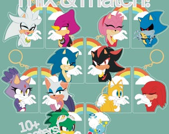 Puede incluir: Una colección de llaveros de personajes con varios personajes de la franquicia Sonic the Hedgehog. Cada llavero tiene un diseño de personaje único con un fondo de arcoíris y nubes. También se ve el texto "mix & match!" y "10+ characters!"