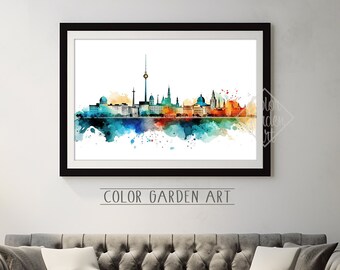 May include: A watercolor painting of the Berlin skyline with a black frame. The painting features a variety of colors, including blue, green, orange, and yellow. The text "COLOR GARDEN ART" is printed below the painting.