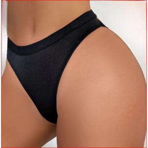 May include: Black high-cut underwear with a smooth, seamless design.