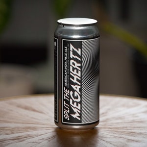 May include: A silver can of Split the MegaHertz American India Pale Ale. The can has a black and white design with a wavy pattern.