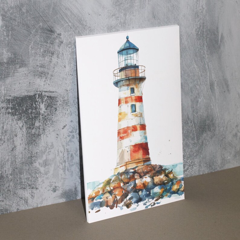 May include: Watercolor painting of a lighthouse with red and white stripes. The lighthouse sits atop a rocky base, with a blue sky and water in the background. The artwork is displayed on a white canvas.