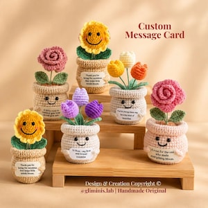 May include: Six crocheted potted plants with smiling faces and custom message cards. The flowers include yellow sunflowers, pink roses, and purple and orange tulips. Each pot features a small white tag with printed text and a happy expression.