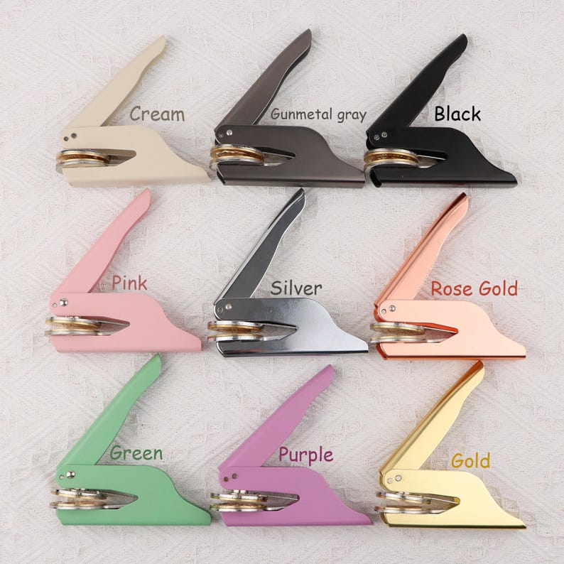 May include: Nine different colored self-inking stamps with a round seal. The colors are cream, gunmetal gray, black, pink, silver, rose gold, green, purple, and gold.