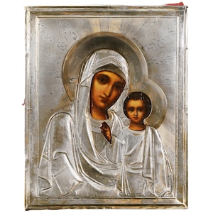 May include: A silver-toned icon depicting the Virgin Mary and baby Jesus. The icon is framed in a silver-toned frame with a red backing.