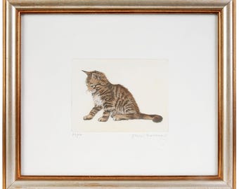 May include: A framed print of a tabby kitten sitting on a white background. The kitten is looking down and has a brown and black striped coat. The print is signed by the artist, "Eric Waller".