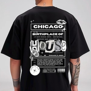 May include: Black t-shirt with a graphic design featuring the word "CHICAGO" and the text "BIRTHPLACE OF HOUSE." The design includes a megaphone, lips, and the phrase "KEEP IT FUN." The shirt is a unisex style.