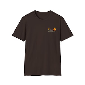 May include: A dark brown t-shirt with a small graphic of a stylized orange and yellow leaf on the left chest. The text "ROOFS DU BOIS" is printed below the graphic.