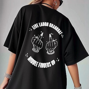 May include: Black oversized t-shirt with a white graphic of two middle fingers and the text "Live Laugh Crankdat Middle Fingers Up".
