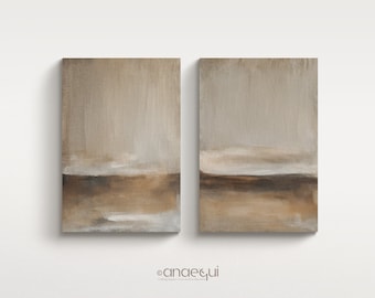 May include: Two rectangular abstract paintings with a neutral color palette. The artwork features a blend of beige, brown, and white hues, creating a serene landscape effect. The paintings are displayed on a white background.