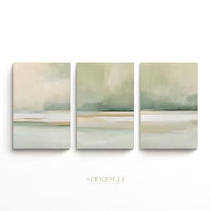 May include: Three-piece abstract canvas art set. Each canvas features a serene landscape with soft green, beige, and blue hues. The artwork evokes a sense of calm and tranquility, perfect for home decor.