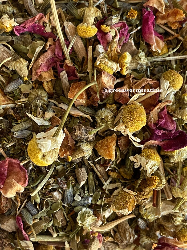 Puede incluir: Primer plano de una mezcla de hierbas y flores secas, incluyendo manzanilla, p&eacute;talos de rosa y lavanda. La mezcla es de color marr&oacute;n claro con toques de rosa y morado. El texto "@greenwormteatime" es visible en la esquina inferior derecha de la imagen.