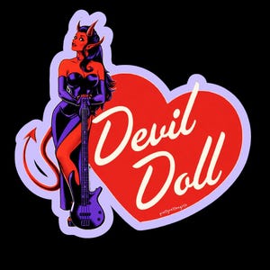 May include: A sticker featuring a devil woman with red skin, black hair, and purple horns, holding a purple bass guitar. The text "Devil Doll" is in white script on a red heart-shaped background, with a purple outline. The background is black.
