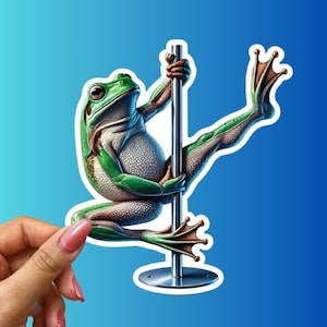 May include: A green frog with a white belly is holding onto a silver pole with its arms and legs. The frog's right leg is extended to the side, and its left leg is bent at the knee. The frog is wearing a white and green patterned outfit. The pole is attached to a silver base.