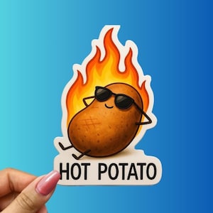 May include: A sticker featuring a cartoon potato wearing sunglasses and relaxing in front of flames. The text "HOT POTATO" is below the potato. The sticker has a white border and is held by a hand.