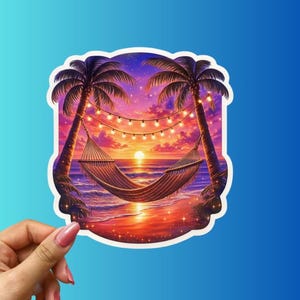 May include: A sticker featuring a tropical beach scene at sunset. Two palm trees frame a hammock strung between them, with a string of lights above. The sky transitions from purple to orange, reflecting on the water. The sticker is held by a hand.