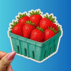 May include: A sticker featuring a basket of ripe red strawberries with green leaves. The strawberries are in a teal green basket with a white border, set against a blue background. The image is a digitally drawn illustration.
