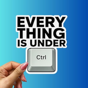 May include: A white sticker with the text "EVERYTHING IS UNDER" in bold black letters. Below the text is a computer key with "Ctrl" printed on it. The sticker is held by a hand with pink nail polish against a blue gradient background.