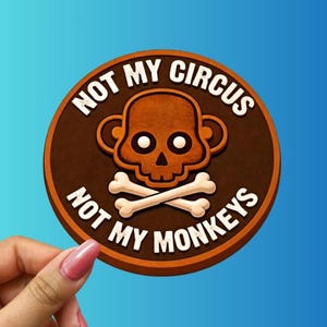 May include: A round, brown sticker with the text "NOT MY CIRCUS, NOT MY MONKEYS" in white. The sticker features a cartoon skull with crossbones. The background is a gradient of blue.