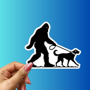 Bigfoot Walking A Dog Sticker - Funny Sasquatch Silhouette Vinyl Decal for Laptops, Water Bottles And Cars - Unique Pet Lover Gift!