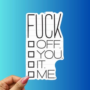 May include: A white sticker with black text that reads "FUCK OFF YOU IT ME" in a checklist format. The sticker is held by a hand with pink nail polish against a blue gradient background.