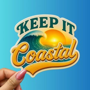 May include: A sticker with a coastal theme. The sticker features a stylized ocean wave, a setting sun, and the words "KEEP IT Coastal" in a retro font. The background is a gradient of blue.