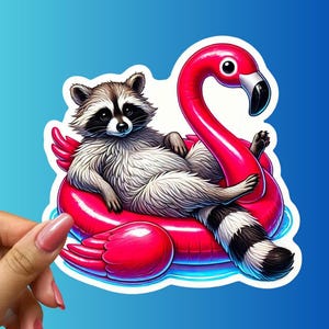 May include: A sticker featuring a raccoon lounging on a pink flamingo pool float. The raccoon has a black and white mask and a fluffy gray and white body. The flamingo float is bright pink with a black beak and a blue background.