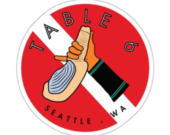 May include: A red circle with a white diagonal line through it. The words "TABLE 6" are on the right side of the circle. The words "SEATTLE, WA" are on the bottom of the circle. The words "TABLE" are on the top of the circle. A cartoon hand is shaking the hand of a clam.