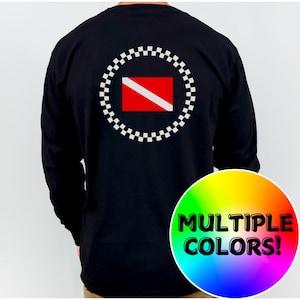 May include: Black long-sleeved shirt with a scuba diving flag design on the back. The design features a red rectangle with a white diagonal stripe, encircled by a white and black chequered pattern. The shirt has the text "MULTIPLE COLORS!" in a rainbow circle.