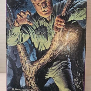 May include: A vintage model kit box featuring "The Wolf Man" with a detailed illustration of the werewolf in a forest setting. The box includes the text "All Plastic Assembly Kit" and the Polar Lights logo.