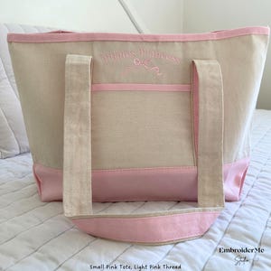 May include: A small pink tote bag with light pink thread embroidery that says "Pirate's Princess".