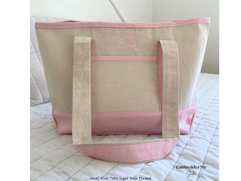 May include: A small pink tote bag with light pink thread embroidery that says "Pirate's Princess".