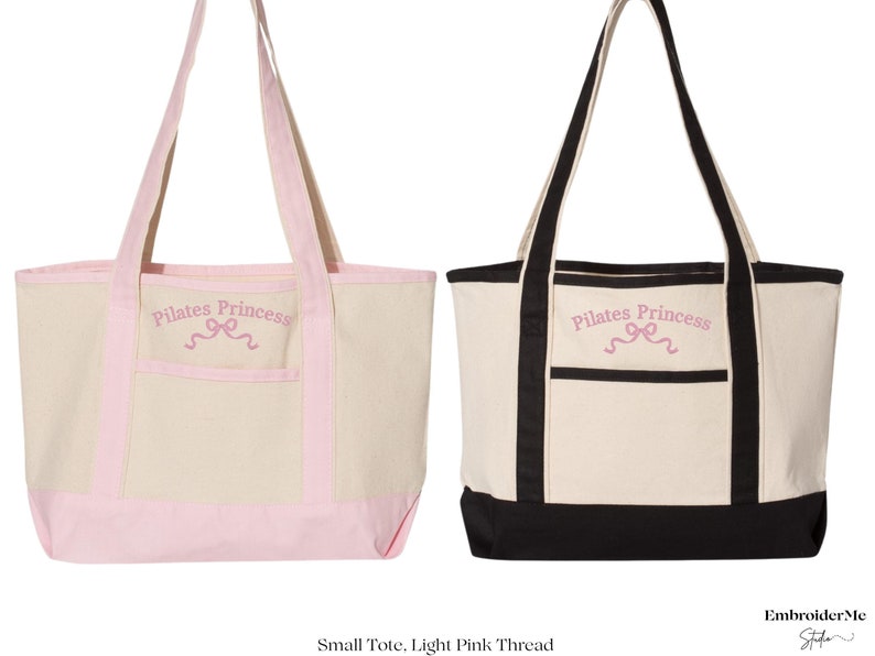 May include: Two canvas tote bags with black and pink trim. The bags have a front pocket and the text "Pilates Princess" embroidered in pink on the front.