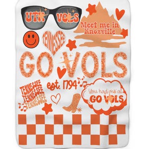 May include: White blanket with orange graphics. Features sunglasses with "UTK VOLS" text, a smiley face, heart-shaped "Tennessee" text, "GO VOLS" text, stars, hearts, and a cowboy boot. Includes "Meet me in Knoxville" and "You had me at GO VOLS" text.