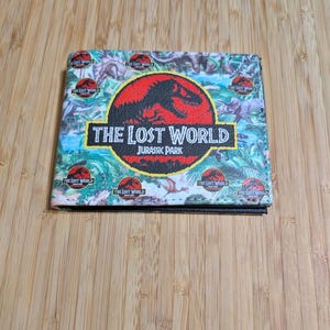 Billetera plegable con el logotipo de Jurassic Park: El mundo perdido